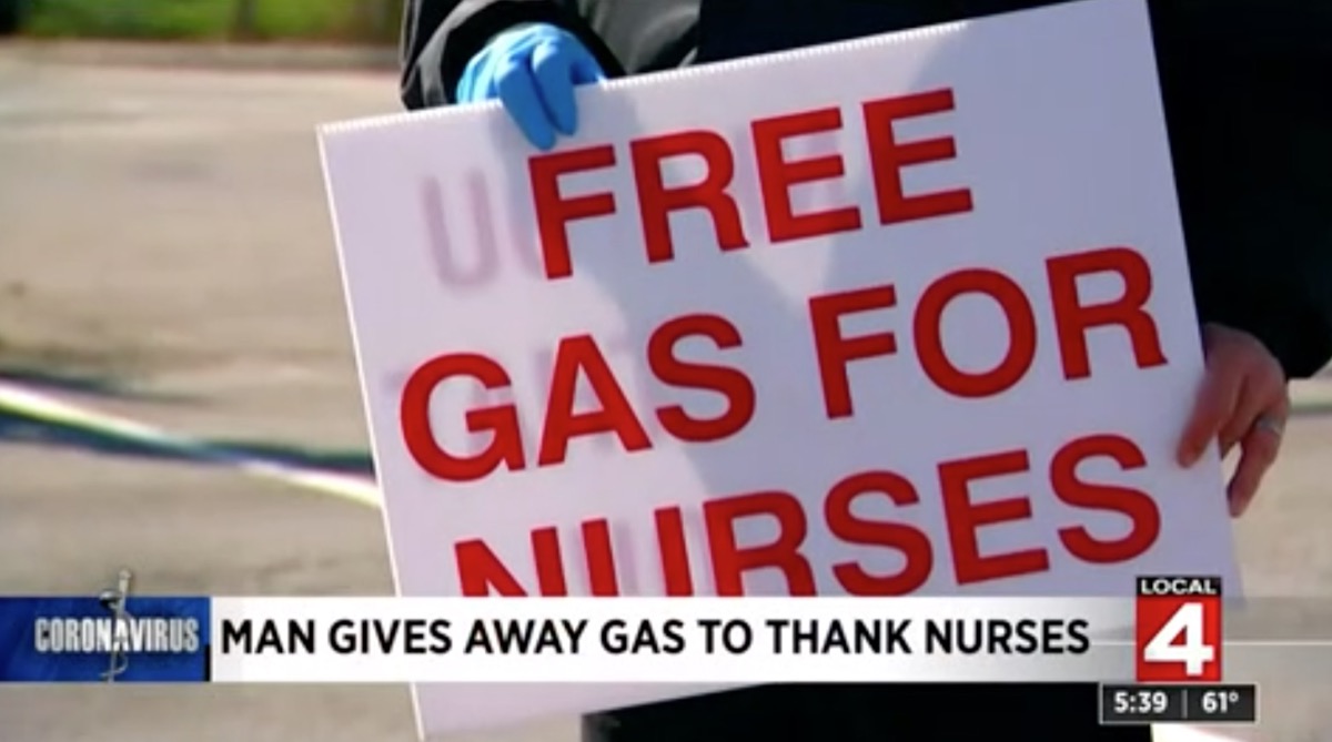 man holding free gas for nurses sign