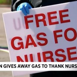 man holding free gas for nurses sign