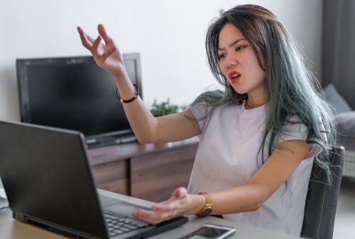 Photo of anger female frustrated at computer when work from home during the COVID-19.