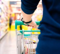 shopper with trolley with blurred motion of supermarket department store
