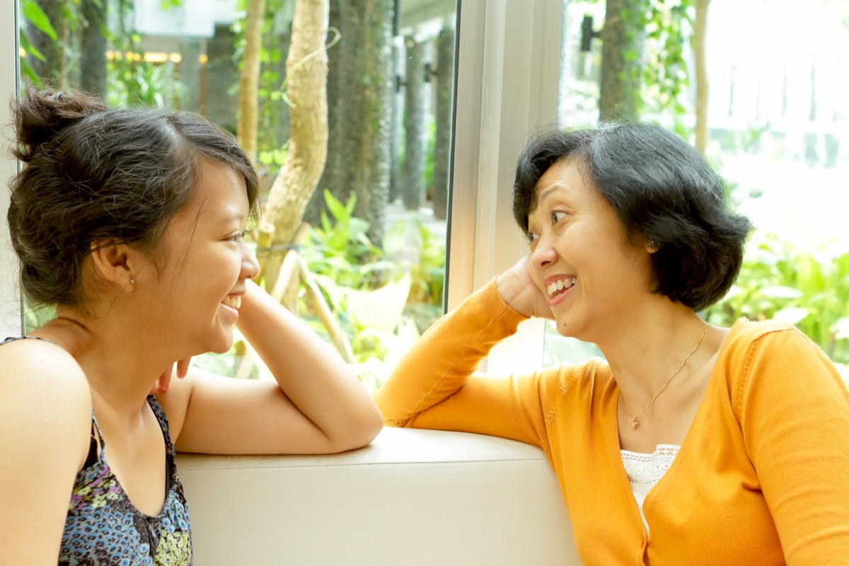 happy asian mother and daughter talking