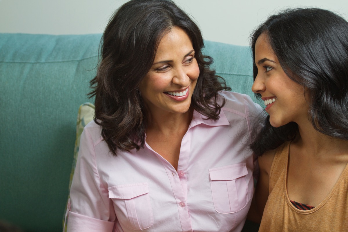 hispanic mother and teen daughter talking
