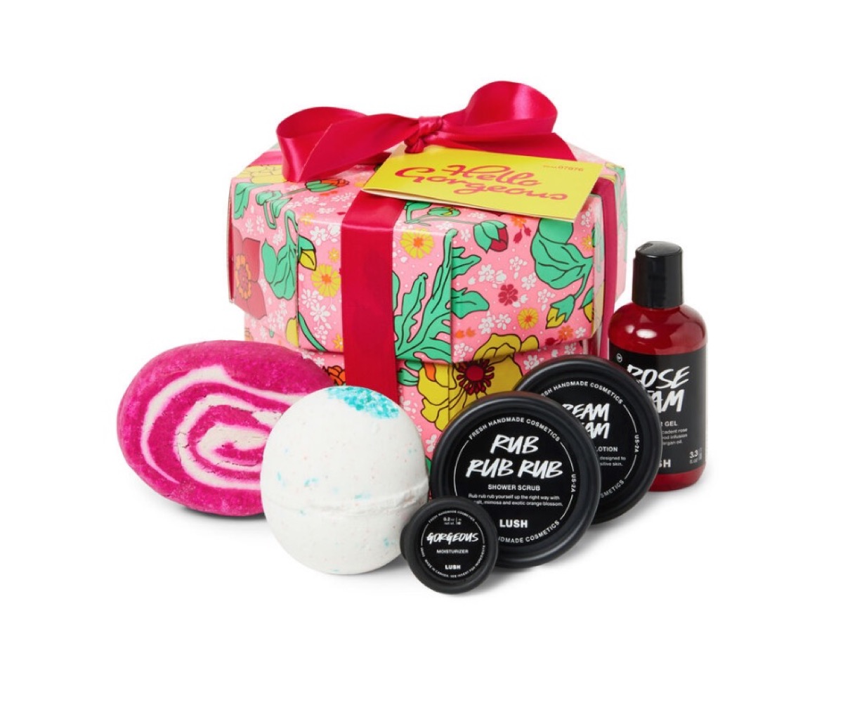 lush gift set with bath bombs, shower gel, moisturizer, and scrub in front of floral gift box