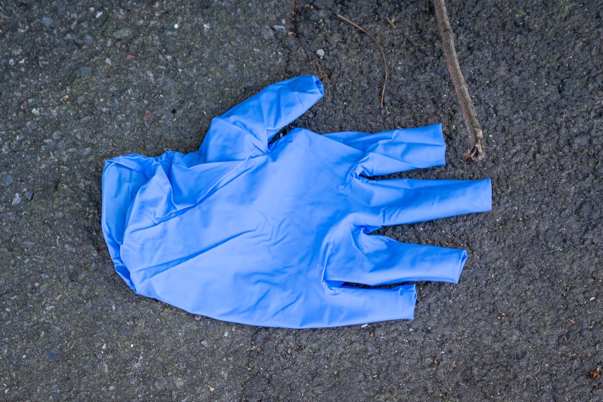 blue plastic glove on street