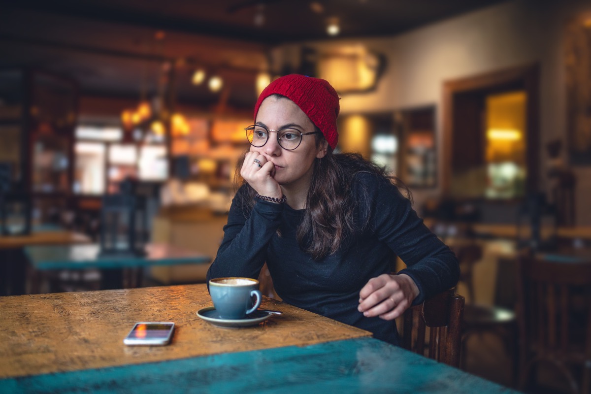 Lovely modern girl enjoying her time at a coffee shop.