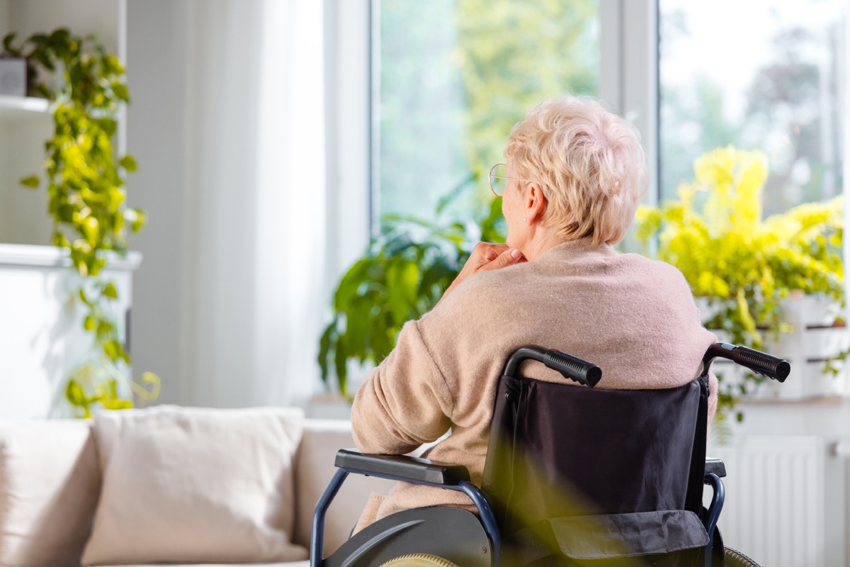 Rear view shot of a senior woman sitting in wheelchair and thinking