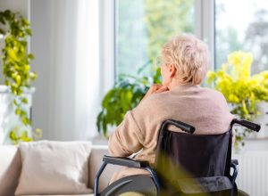 Rear view shot of a senior woman sitting in wheelchair and thinking