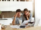 Stressed couple looking at paperwork