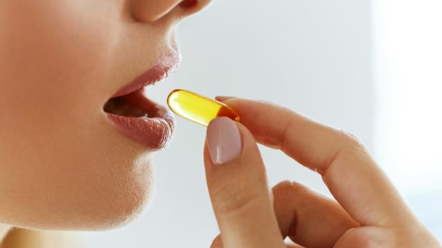 Woman taking a supplement