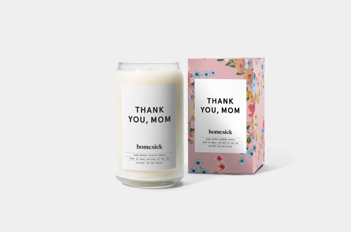 white candle in glass jar and floral box with white labels reading "Thank You, Mom"