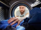 man washing his blue laundry