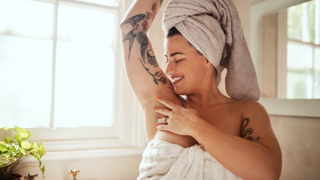woman smelling herself after a shower