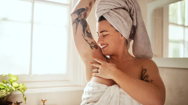 woman smelling herself after a shower