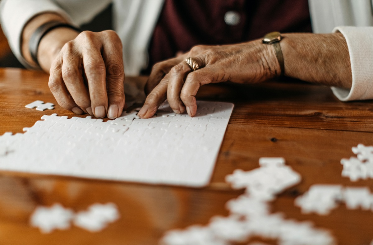 Old woman playing puzzle game