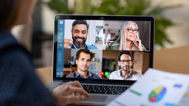 woman on five-way video call with coworkers at work