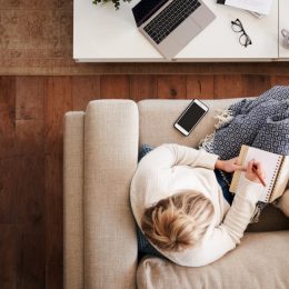 woman on couch working from home