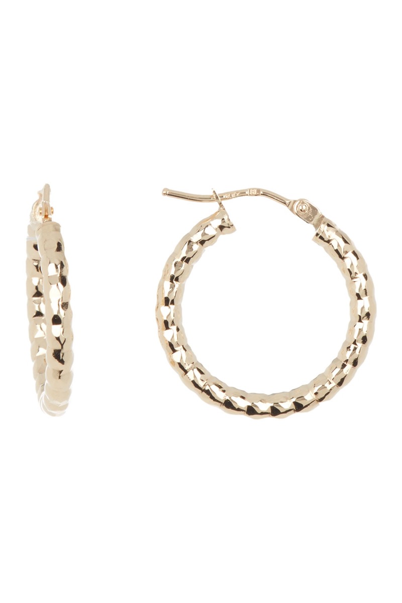 small textured gold hoop earrings on white background