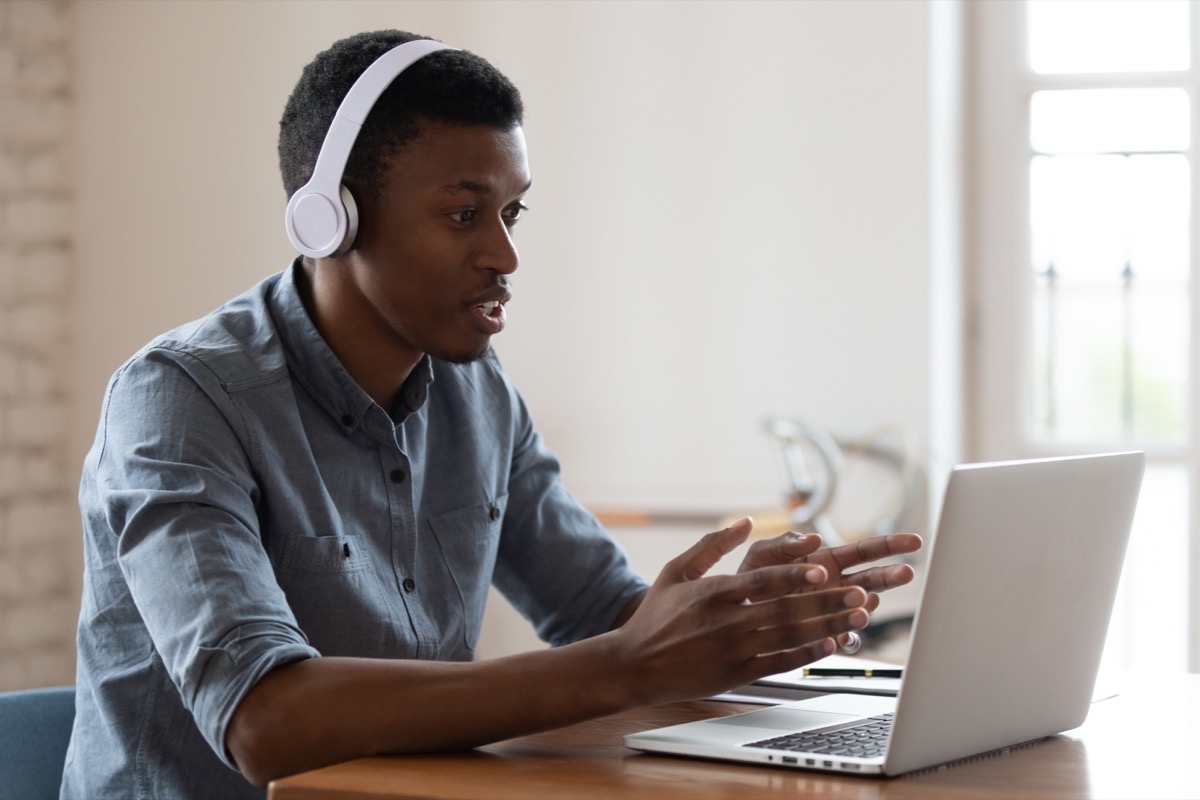 young black man wearing headphones on video call