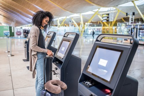 Woman using check-in kiosk at the airport