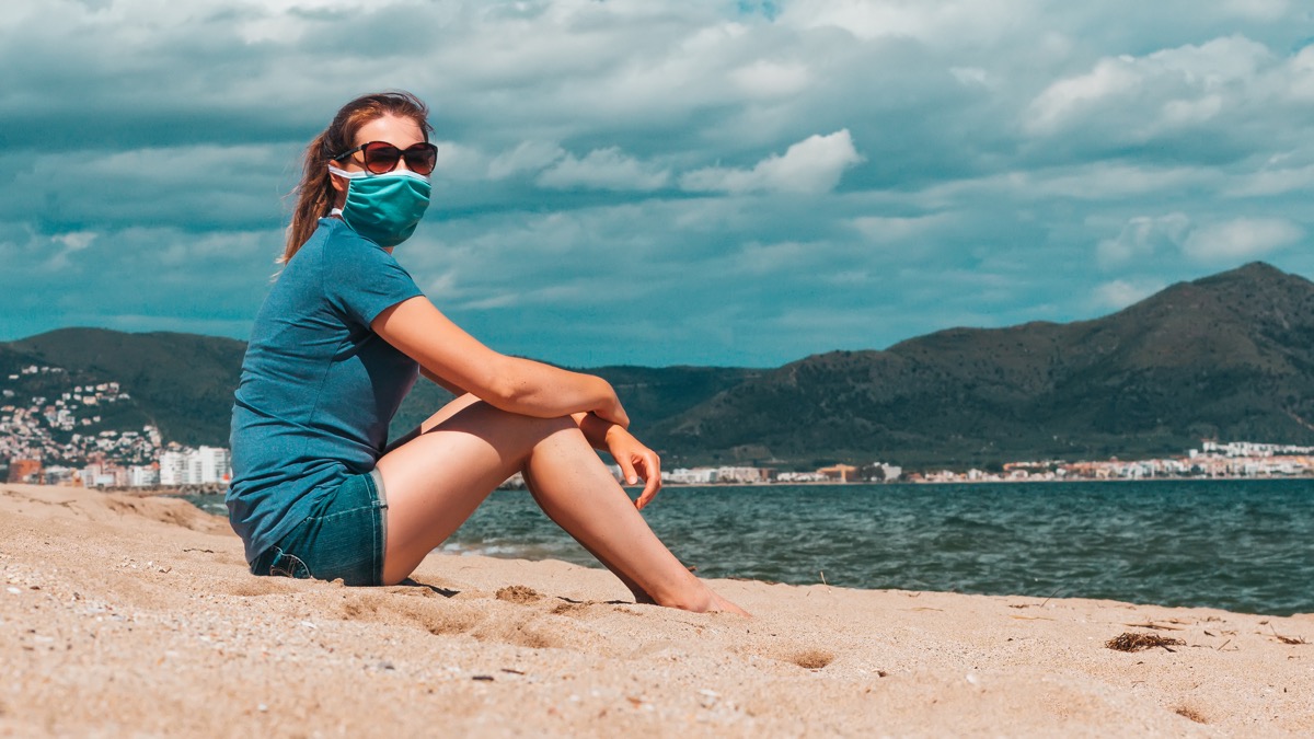 Woman wearing mask on thebeach