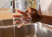 Woman washing hands at sink