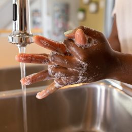 Woman washing hands at sink