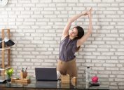 Woman stretching at her desk