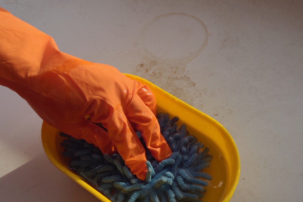 Dipping sponge into disinfectant