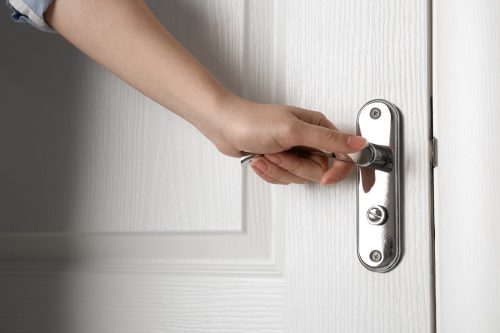 Opening door touching doorknob