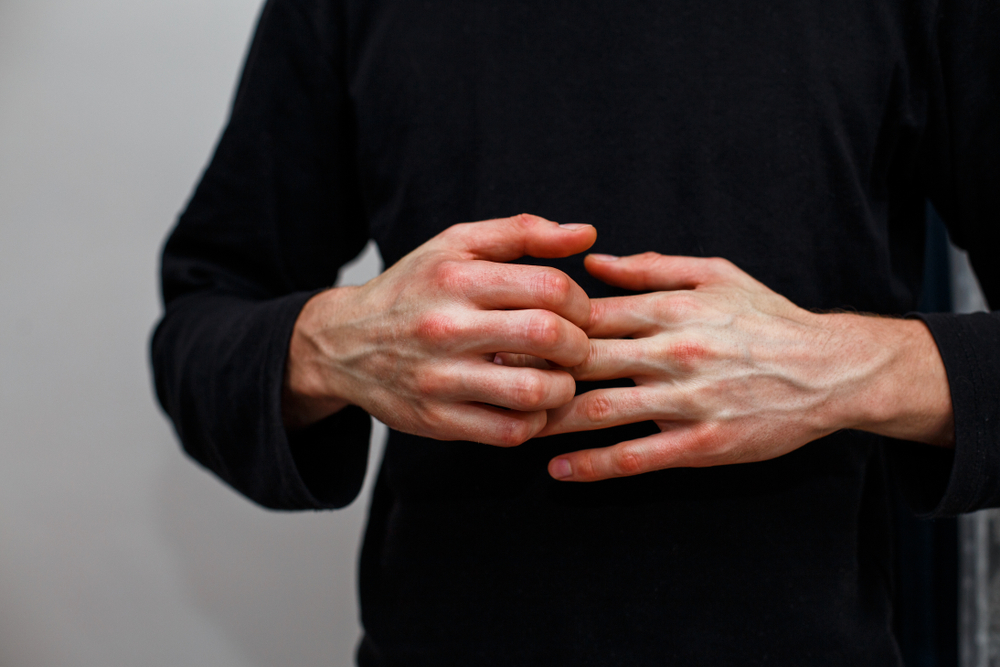 closeup of man itching hands
