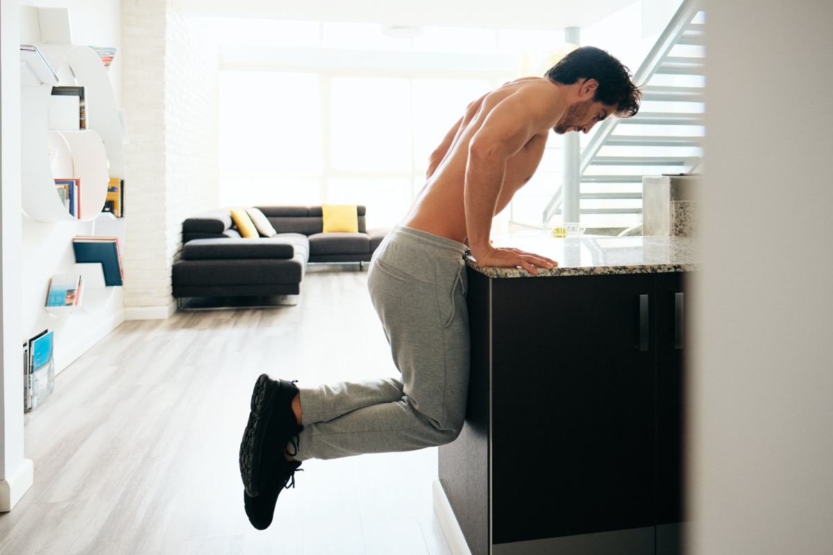 Man exercising in kitchen