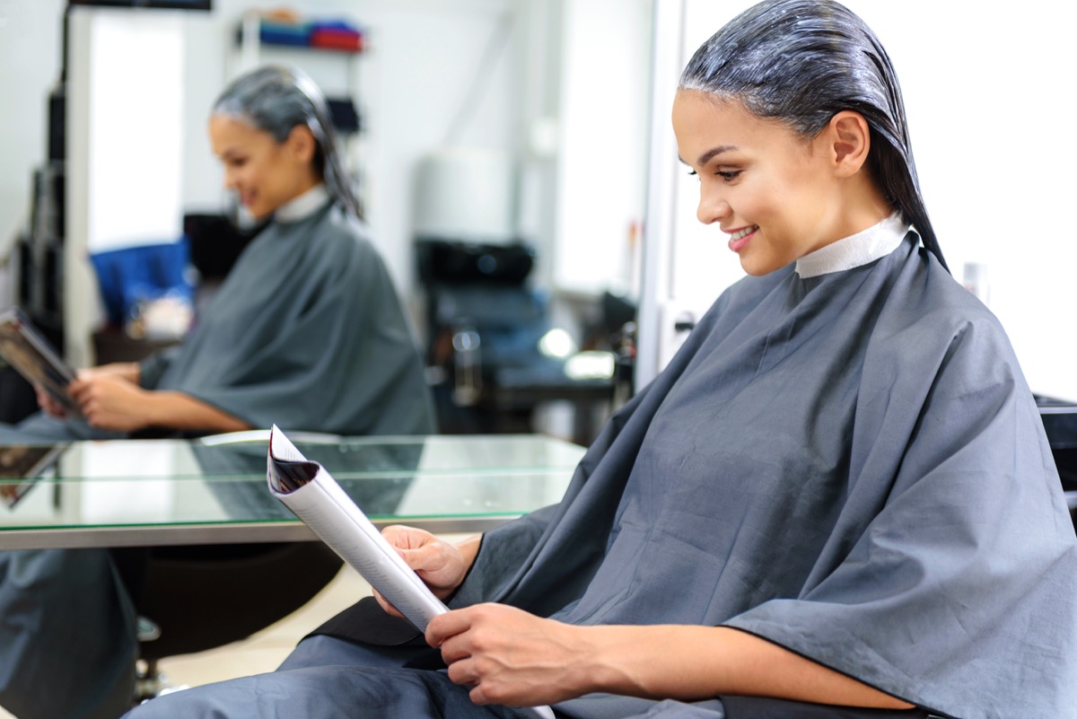 Woman reading a magazine in hair salon