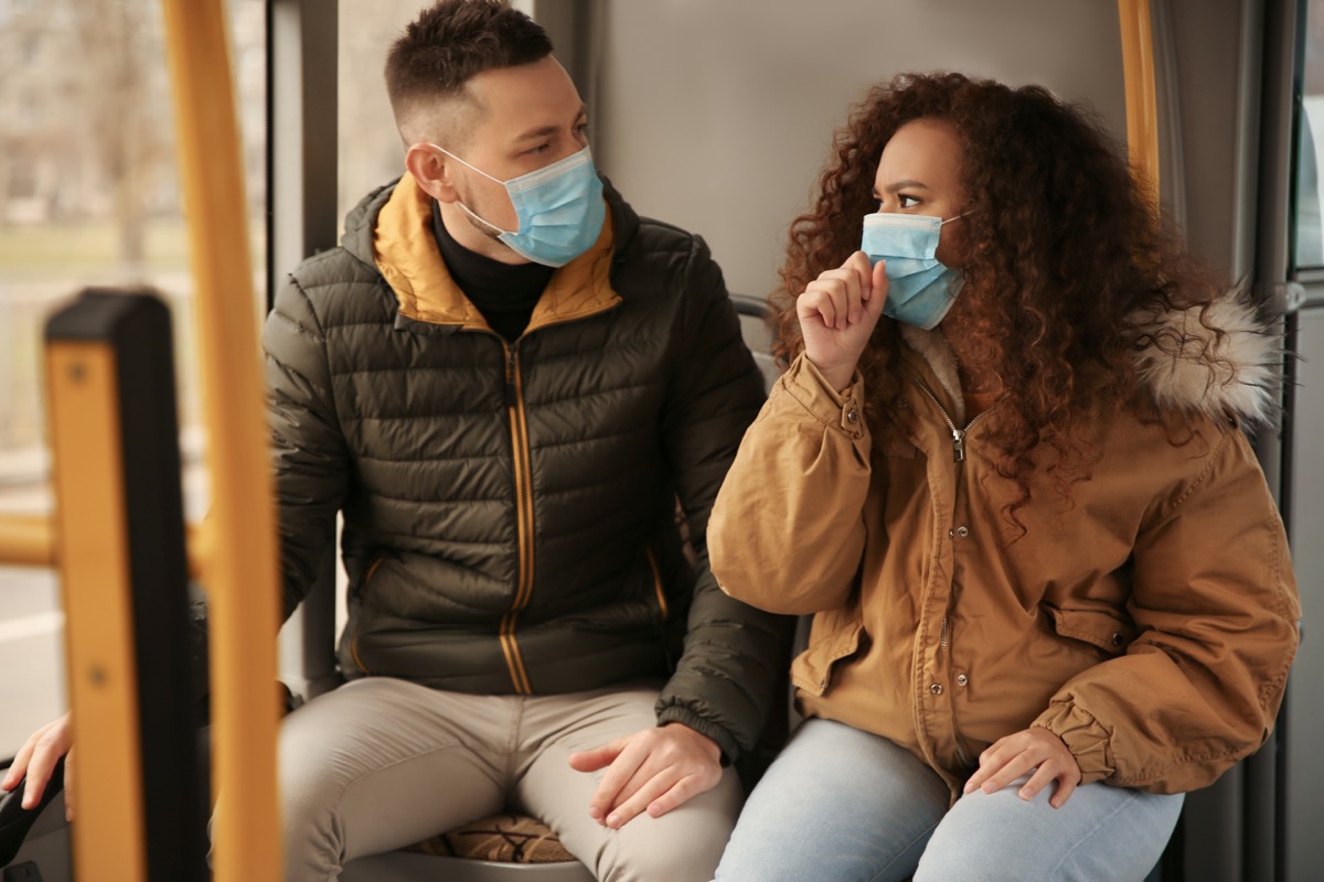 Couple wearing masks on public transportation together