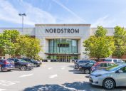 CHARLOTTE, NC, USA-28 July 19: Entrance to Nordstrom Department store, with crowded parking lot on a sunny summer day. (CHARLOTTE, NC, USA-28 July 19: Entrance to Nordstrom Department store, with crowded parking lot on a sunny summer day., ASCII, 119