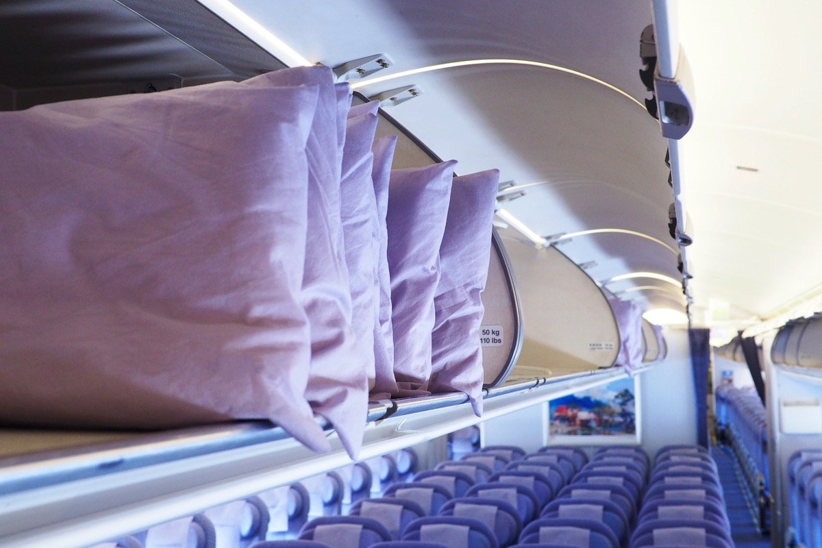pillows in an overhead compartment of a plane