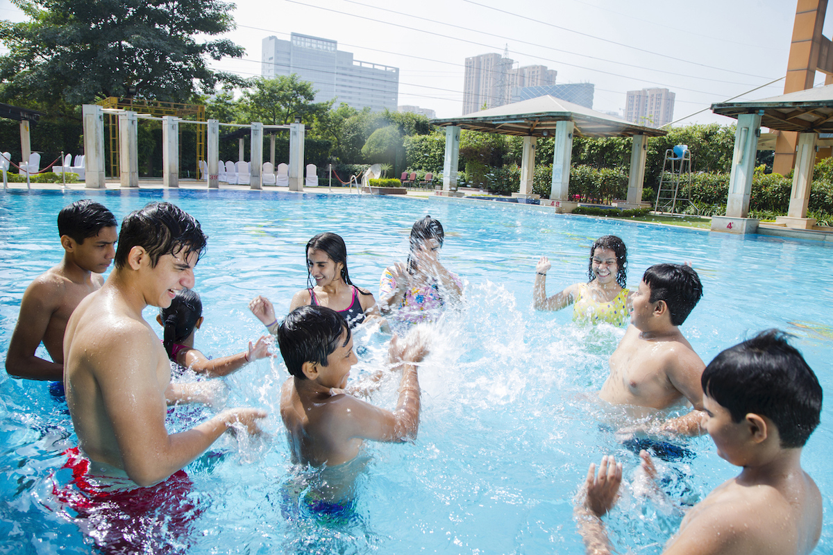 Multi-Ethnic group of teenagers in public swimming pool