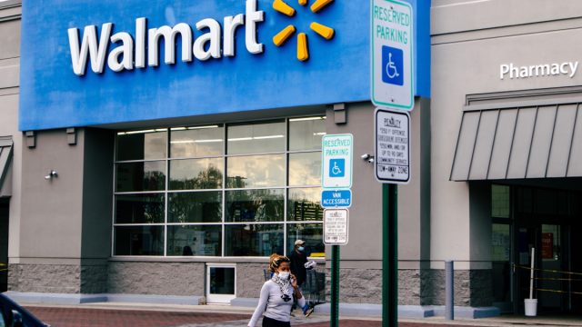 walmart exterior with shoppers exiting into parking lot