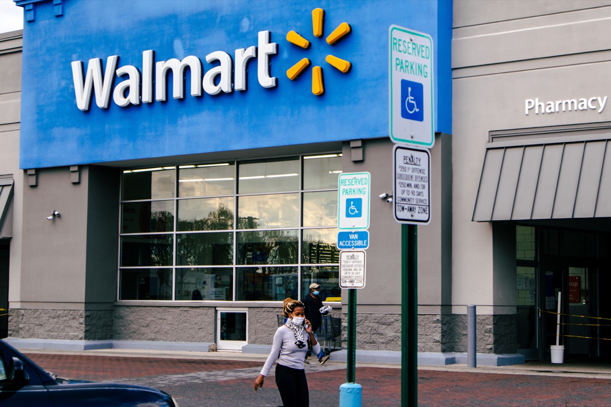 walmart exterior with shoppers exiting into parking lot