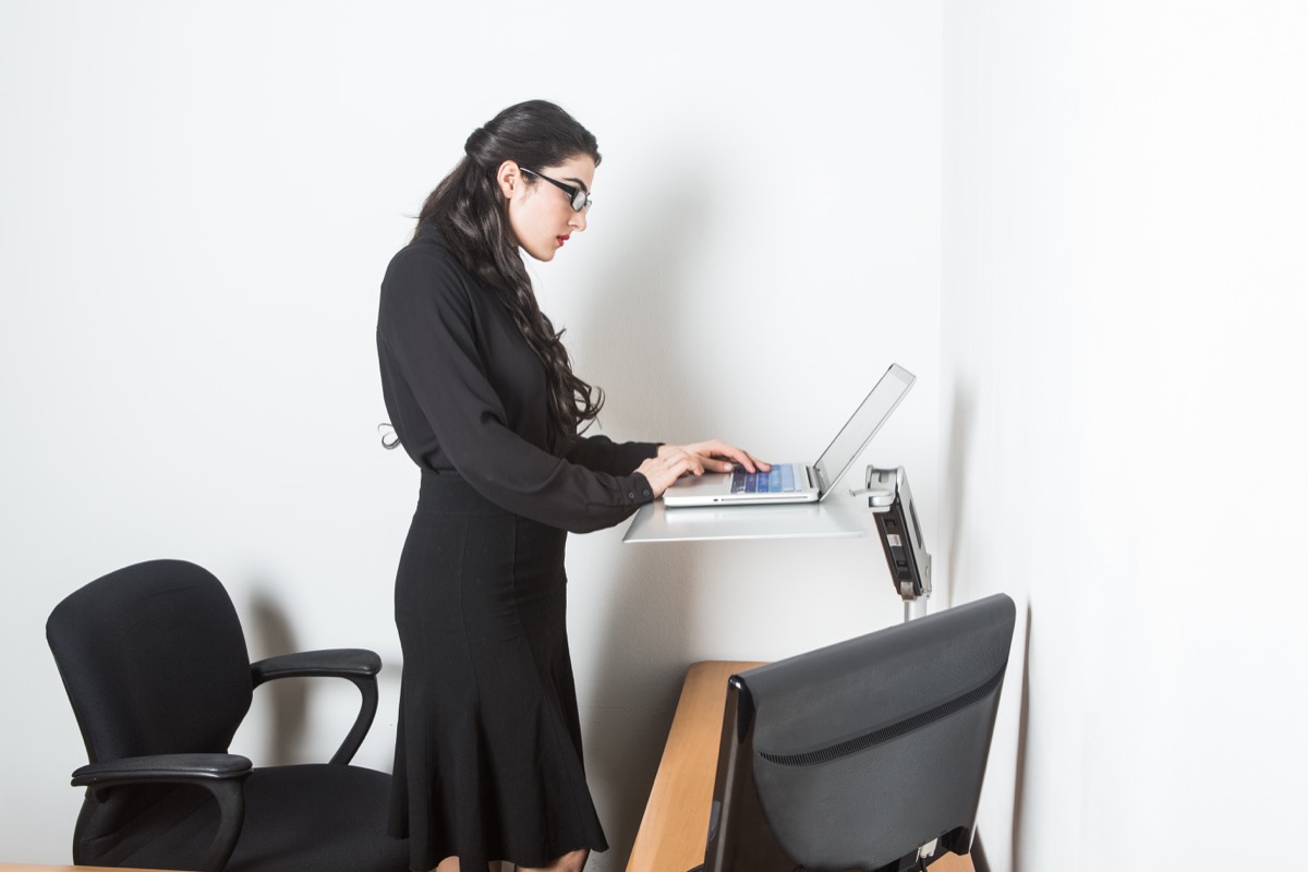 Woman using a stand desk at home