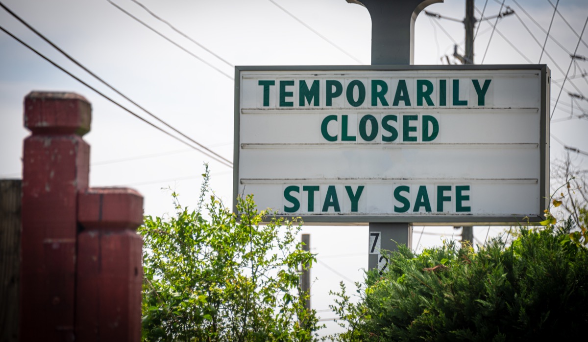 A sign tells customers that a business is temporarily closed due to the COVID-19 pandemic.