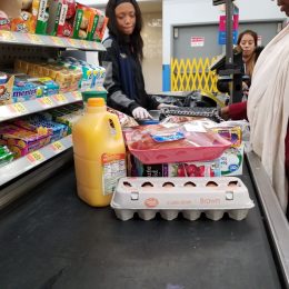 woman buying groceries at walmart checkout