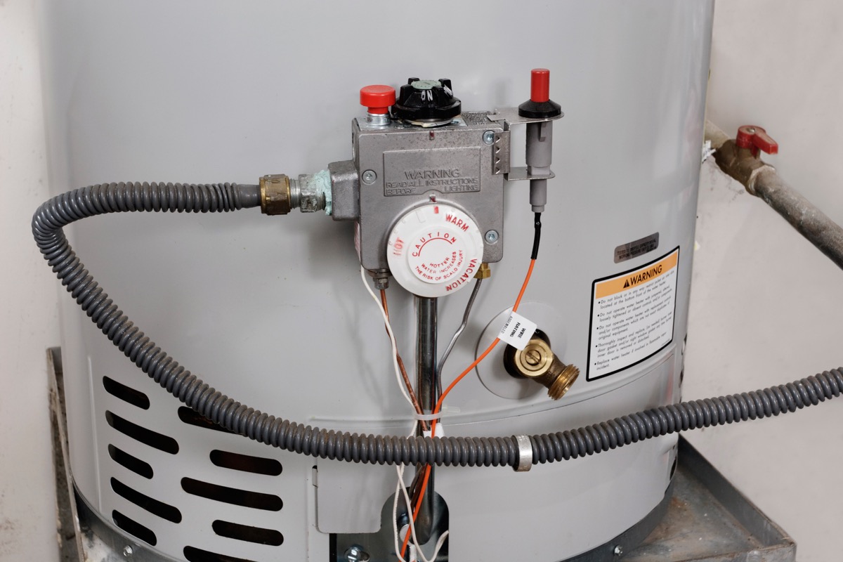 water heater with hose, control knobs, and vents