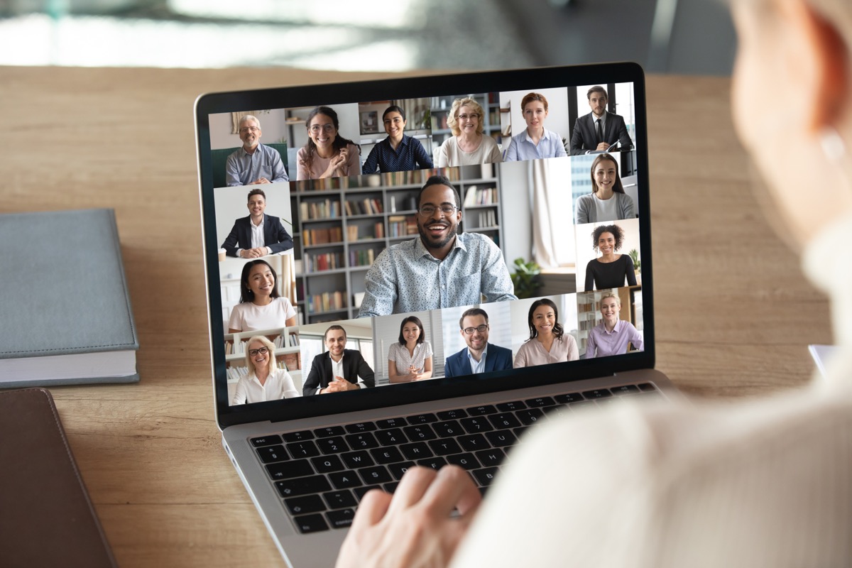 white woman sitting on laptop having zoom meeting or video call