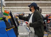 woman wearing mask and gloves at walmart checkout