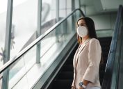 woman wearing N95 mask to protect pollution PM2.5 and virus. COVID-19 Coronavirus and Air pollution pm2.5 concept.