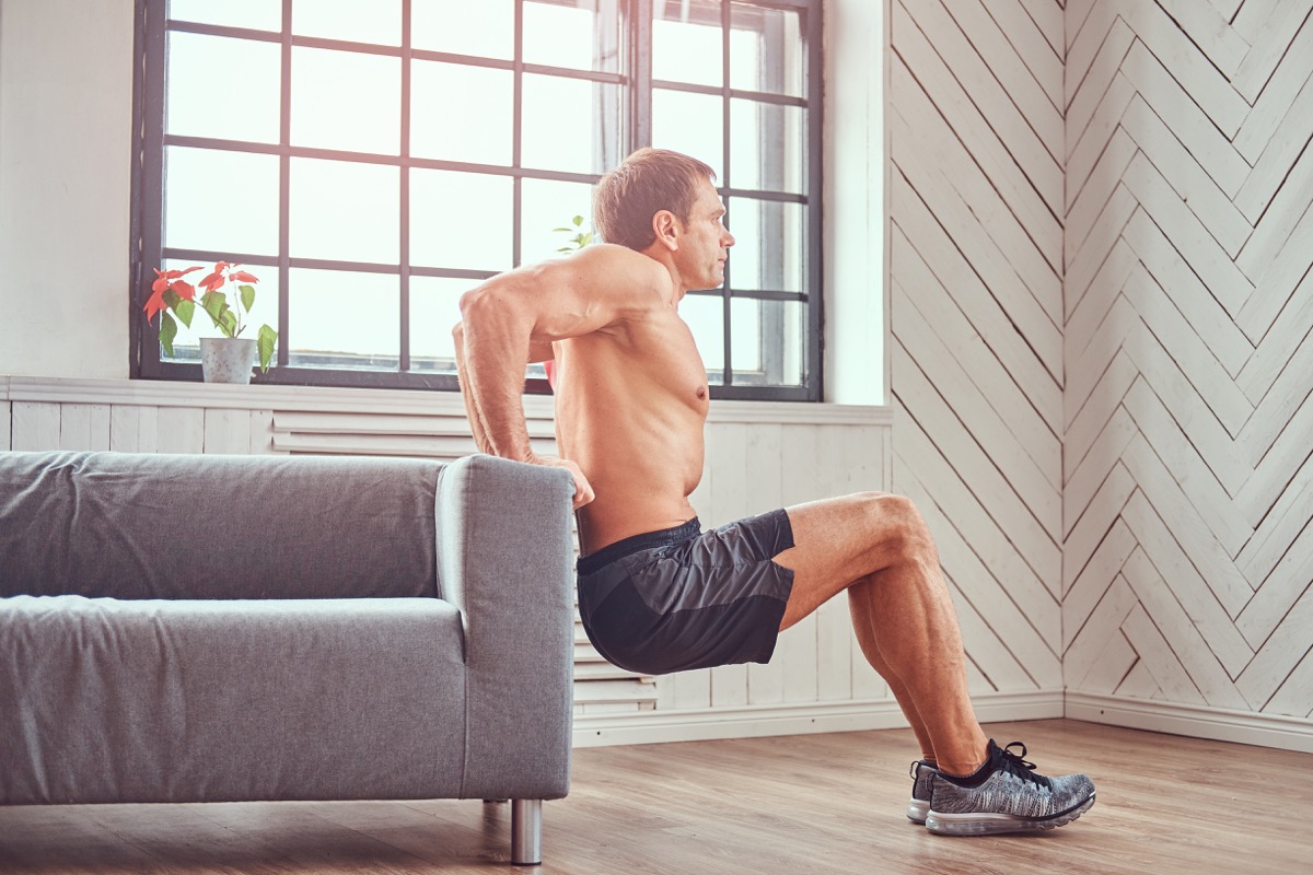 Man doing an at home exercise with couch
