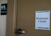 sign on public restroom saying it's closed