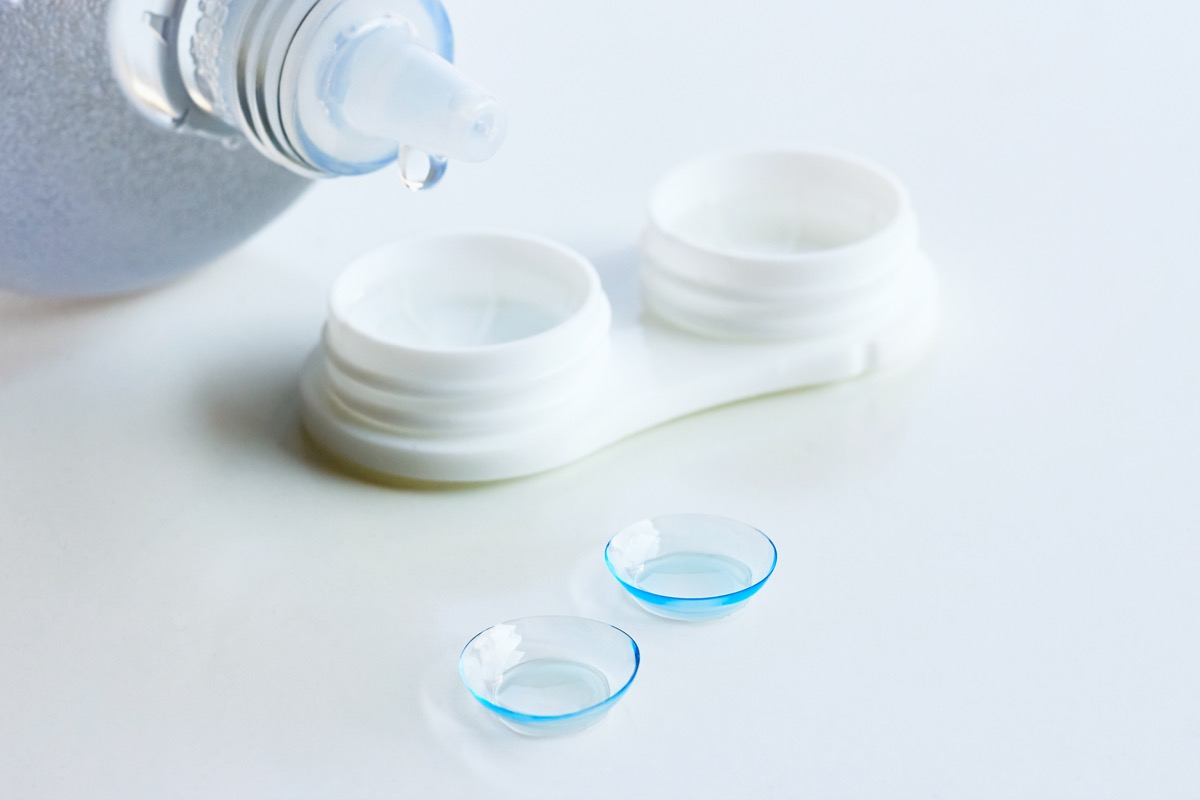 contact lenses case and solution on white countertop