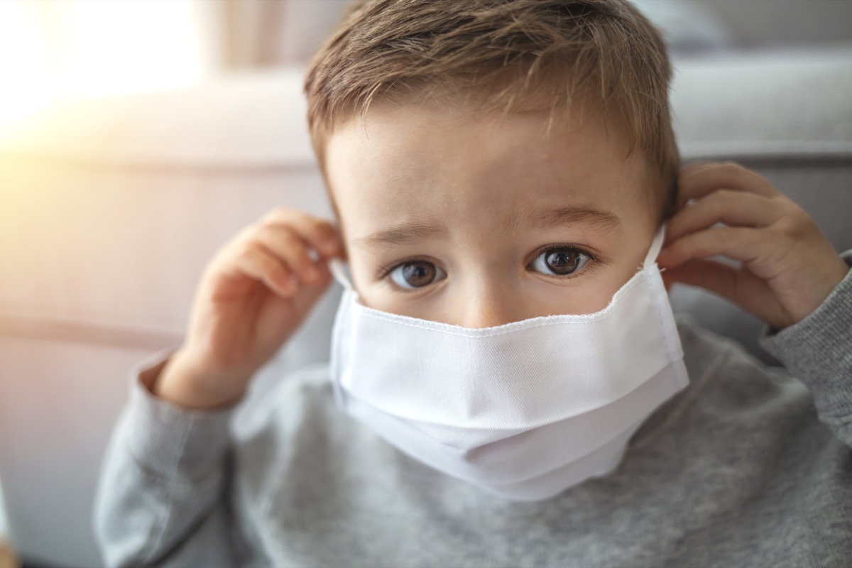 2-3 years old cute child wearing surgical mask. Little boy trying to stay healthy by wearing a mask to protect him against corona virus covid-19 / 2019-nCov. Little boy wearing anti virus mask staying at home