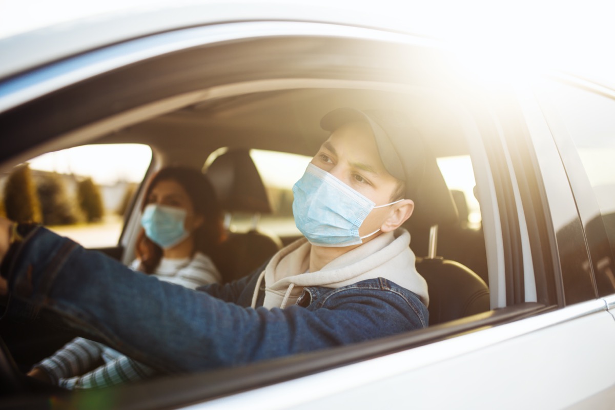 couple wearing face masks in car